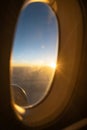 Sun rise from the window of an airplane seat. Sun is shining with a glare coming through the window glass. Royalty Free Stock Photo
