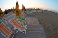 Sun rises on the beach still deserted, with Sun umbrellas a