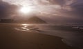 The sun rises between the clouds on the beach of the Zurriola city of Donostia, Euskadi Royalty Free Stock Photo