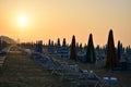 The sun rises at dawn and the beach is still deserted with umbrellas still closed