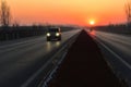 The sun rises at the end of the stretch of the road Royalty Free Stock Photo