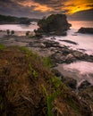 the sun rises over the beautiful beach looking over the cliffs