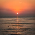 Sun rises over serene morning sea at Cha Am Beach