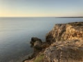 The sun rises and is seen from behind the mountains, on the horizon the coastline of the sea , is planned a sultry clear summer Royalty Free Stock Photo