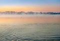 Sun rising above lake, the lake in the morning sunrise with fog on the water Royalty Free Stock Photo