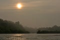 Sun rising above the river in Chitwan National Park in Nepal Royalty Free Stock Photo