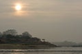 Sun rising above the river in Chitwan National Park in Nepal Royalty Free Stock Photo