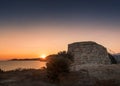 Sun rising behind Genoese tower at Lozari in Corsica