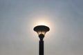 Sun rising behind the lamp. Royalty Free Stock Photo