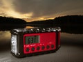 Sun rising over a lake with red weather radio Royalty Free Stock Photo