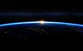 The sun is rising over the planet Earth in outer space Royalty Free Stock Photo