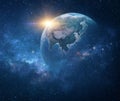 Sun rising over Planet Earth in outer space Royalty Free Stock Photo