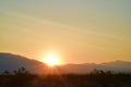 Sun rising over ridge Spring Mountains Mojave Desert town Pahrump, Nevada, USA Royalty Free Stock Photo