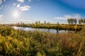 Sun is rising, walley with grass, bushes and river Royalty Free Stock Photo