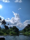 Sun and river sky cloud palm and many trees Royalty Free Stock Photo