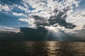 The sun\'s rays break through the clouds over Lake Ontario.