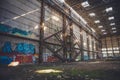 The sun's rays break through the roof of an abandoned warehouse