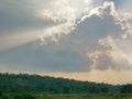 Sun`s rays bursting through the cloud onto the earth Royalty Free Stock Photo