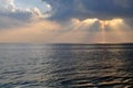 The sun`s rays through the clouds above the sea. Royalty Free Stock Photo