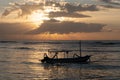 The sun`s rays over the sea, burst out of the cloud. Dramatic sunset on the sea, beautiful peaceful scene, rays of light shine in Royalty Free Stock Photo