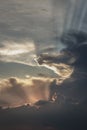 The sun`s rays passing through the clouds and shining form an interesting light pattern against the sky Royalty Free Stock Photo