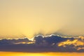 The sun`s rays penetrate through dark cloud at sunset Royalty Free Stock Photo