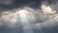 The sun`s rays penetrate through the dark clouds during sunset, panorama Royalty Free Stock Photo