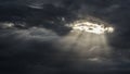 The sun`s rays shine through a hole in the continuous cloud cover Royalty Free Stock Photo