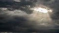 The sun's rays shine through a hole in the continuous cloud cover Royalty Free Stock Photo