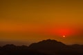 Sun is seen from the top of Mount Moses at the beginning of sunrise over mountains Royalty Free Stock Photo