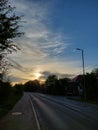 Sun set in a blue sky and empty road Royalty Free Stock Photo