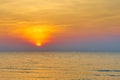 Sun set on water sea with waves and orange color sky background Royalty Free Stock Photo