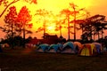 Sun set time on camping ground. National park camping tents area in the midst of nature sun dawn multi color abstract sky Royalty Free Stock Photo