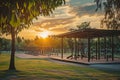 The sun sets in the background, casting a warm glow over a park with benches, A sunset view on a open-air gym at a park, AI Royalty Free Stock Photo