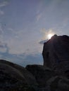 the sun sets beautifully and hides behind a rock Royalty Free Stock Photo