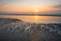 Sun sets behind a cloud bank over sea Royalty Free Stock Photo