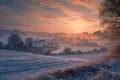 The sun sets behind the horizon, casting a warm golden glow on a frost-covered field, creating a serene and captivating winter Royalty Free Stock Photo