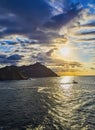 The sun sets behind the Santa Clara Island and The Igueldo Mount. The Concha Bay, San Sebastian. Spain. Royalty Free Stock Photo