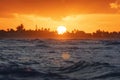 sun sets behind the trees on the horizon. Beautiful sunset in the Indian ocean. Evening seascape in the tropics. Sunset over the Royalty Free Stock Photo