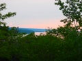 Pale pink Sun sets over Cayuga Lake