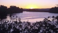 The sun sets over the Hawkesbury River at Windsor, west of Sydney, Australia. In the distance two fishing boats and the Blue