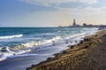 The sun sets over the horizon of Badalona, Spain, reflecting off the waves of its idyllic bay. Surfers take advantage of the wind Royalty Free Stock Photo