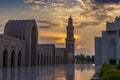 The sun sets over a mosque at sunset in Muscat, Oman Royalty Free Stock Photo