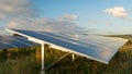 Sun sets on solar panels on energy farm Royalty Free Stock Photo