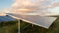 Sun sets on solar energy farm Royalty Free Stock Photo