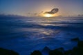 Sun setting above the horizon as viewed from Southern Breakwater Viewing Platform in Greymouth, New Zealand