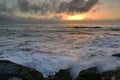 Sun setting above the horizon as viewed from Southern Breakwater Viewing Platform in Greymouth, New Zealand