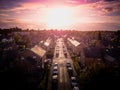 Sun setting with atmospheric effect over traditional British houses and tree lined streets.