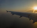 The sun setting behind an aircraft wing on approach to Luga International Airport, Malta Royalty Free Stock Photo