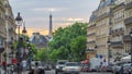 Sun setting behind a building on a Parisian Soufflot street timelapse with Eiffe tower on background